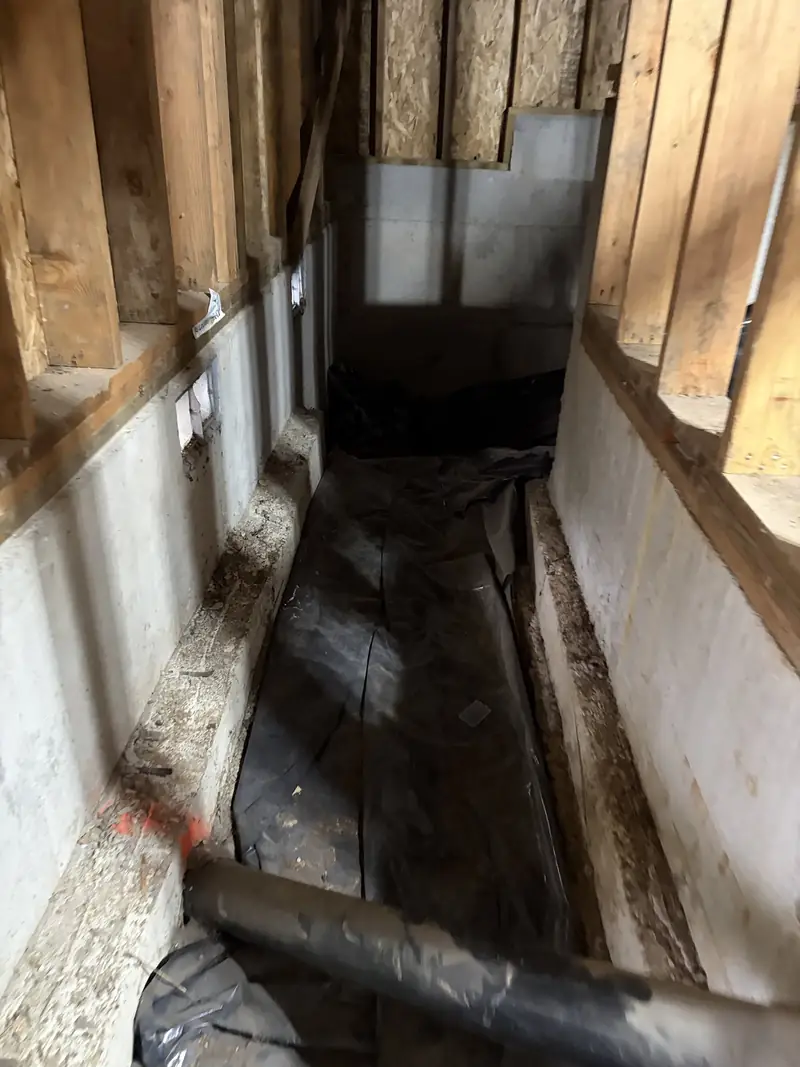 Concrete foundation stem walls inside a crawl space during a project